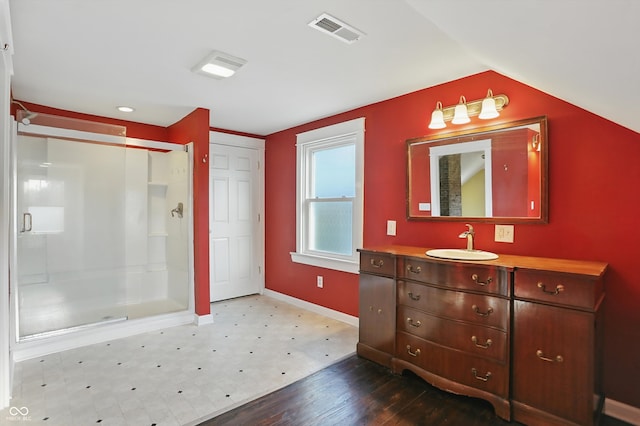 808 N Layman Ave, Indianapolis, IN 46219 - full bath featuring vanity, a shower stall, vaulted ceiling, and wood finished floors
