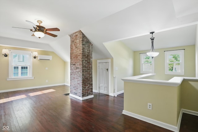 808 N Layman Ave, Indianapolis, IN 46219 - empty room featuring a wall mounted air conditioner, wood finished floors, a ceiling fan, and vaulted ceiling