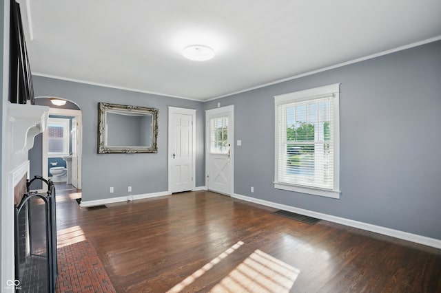 808 N Layman Ave, Indianapolis, IN 46219 - unfurnished living room with ornamental molding, wood finished floors, and arched walkways