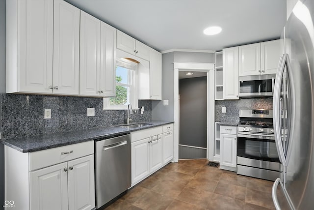808 N Layman Ave, Indianapolis, IN 46219 - kitchen featuring stainless steel appliances, open shelves, white cabinets, and backsplash