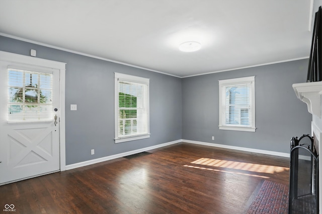 808 N Layman Ave, Indianapolis, IN 46219 - unfurnished living room featuring ornamental molding, healthy amount of natural light, and dark wood-style flooring