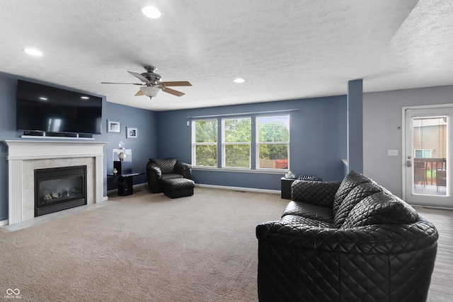 10312 Gladeview Dr, Indianapolis, IN 46239 - living room featuring a textured ceiling, carpet floors, a ceiling fan, recessed lighting, and a fireplace
