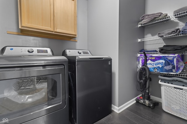 10312 Gladeview Dr, Indianapolis, IN 46239 - washroom featuring independent washer and dryer, cabinet space, and dark wood-style floors