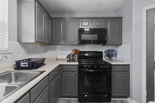 10312 Gladeview Dr, Indianapolis, IN 46239 - kitchen featuring black appliances, gray cabinetry, light countertops, and tasteful backsplash