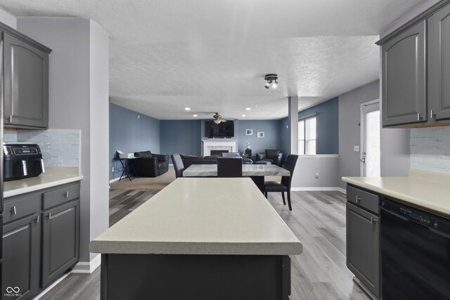10312 Gladeview Dr, Indianapolis, IN 46239 - kitchen featuring dishwasher, gray cabinets, tasteful backsplash, a fireplace, and a textured ceiling