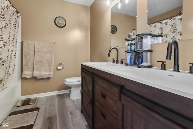 10312 Gladeview Dr, Indianapolis, IN 46239 - full bathroom featuring double vanity, wood finished floors, and a shower with curtain