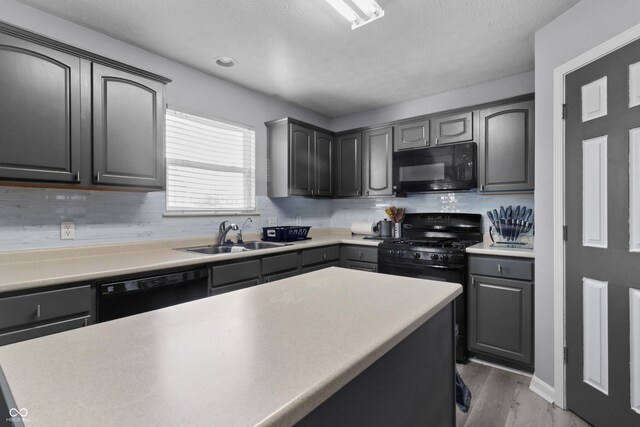 10312 Gladeview Dr, Indianapolis, IN 46239 - kitchen featuring black appliances, backsplash, light wood finished floors, gray cabinets, and light countertops