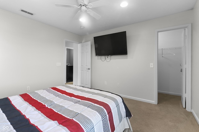 10312 Gladeview Dr, Indianapolis, IN 46239 - bedroom featuring a walk in closet, light carpet, a closet, and a ceiling fan