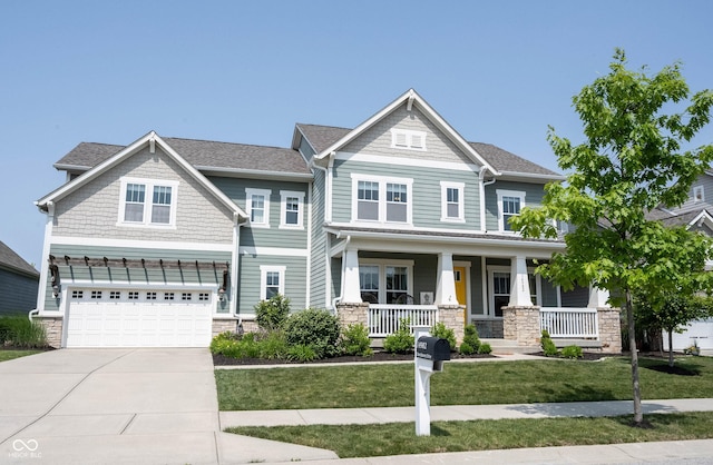 14982 Dawnhaven Dr, Westfield, IN 46074 - craftsman-style home with stone siding, driveway, a garage, a porch, and a front lawn