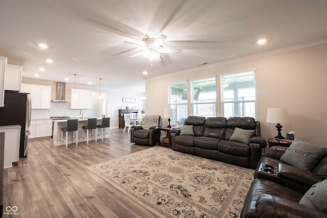 9671 Holborn Ave, Mccordsville, IN 46055 - living area with a ceiling fan, crown molding, recessed lighting, and light wood finished floors