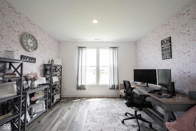 9671 Holborn Ave, Mccordsville, IN 46055 - office area featuring wallpapered walls, an accent wall, and wood finished floors
