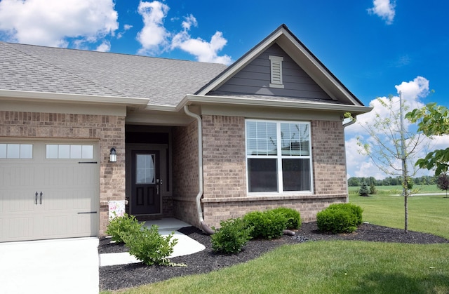 9671 Holborn Ave, Mccordsville, IN 46055 - view of front of house featuring brick siding, an attached garage, a front lawn, and roof with shingles