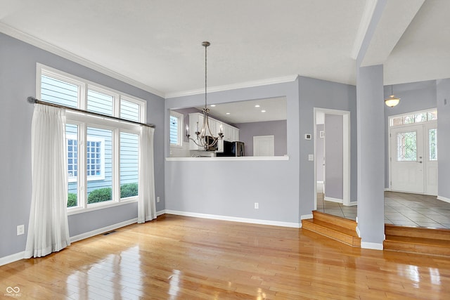4810 Crystal River Ct, Indianapolis, IN 46240 - unfurnished dining area with light wood-style floors, a chandelier, plenty of natural light, and ornamental molding