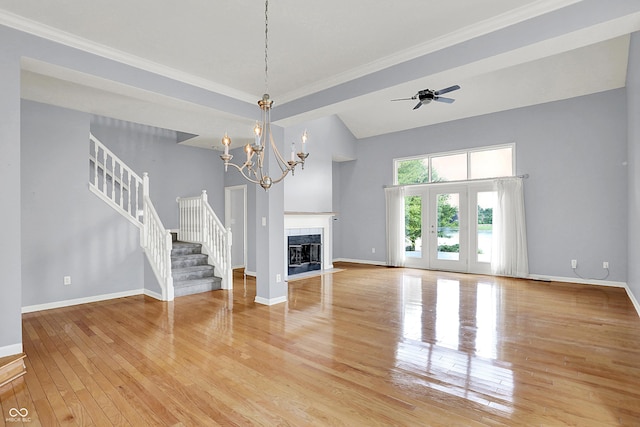 4810 Crystal River Ct, Indianapolis, IN 46240 - unfurnished living room with light wood-type flooring, stairs, a towering ceiling, a ceiling fan, and a chandelier
