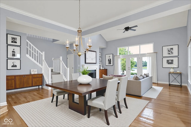 4810 Crystal River Ct, Indianapolis, IN 46240 - dining space with light wood-style flooring, stairway, a chandelier, a ceiling fan, and ornamental molding