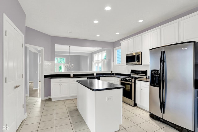 4810 Crystal River Ct, Indianapolis, IN 46240 - kitchen with stainless steel appliances, dark countertops, a chandelier, recessed lighting, and a center island