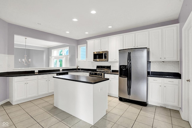 4810 Crystal River Ct, Indianapolis, IN 46240 - kitchen featuring stainless steel appliances, a chandelier, backsplash, dark countertops, and white cabinetry