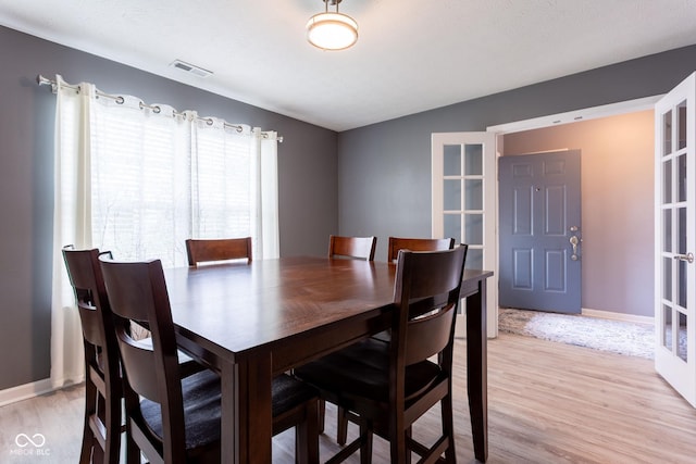 4353 W Parkway Ct, New Palestine, IN 46163 - dining room featuring light wood-style floors, baseboards, and french doors