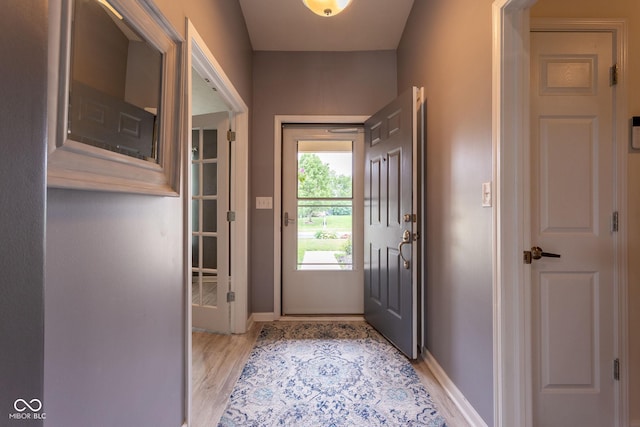 4353 W Parkway Ct, New Palestine, IN 46163 - doorway to outside with baseboards and light wood-type flooring