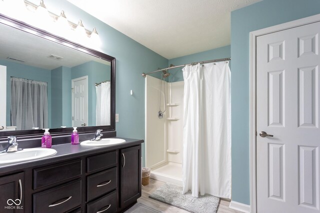 4353 W Parkway Ct, New Palestine, IN 46163 - full bathroom with double vanity, wood finished floors, and curtained shower