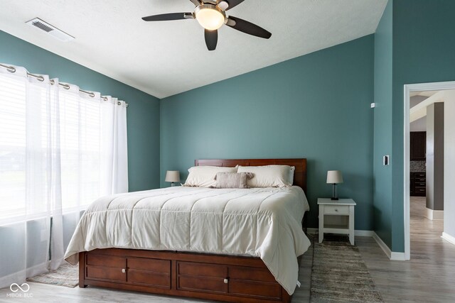 4353 W Parkway Ct, New Palestine, IN 46163 - bedroom with lofted ceiling, wood finished floors, baseboards, and a ceiling fan