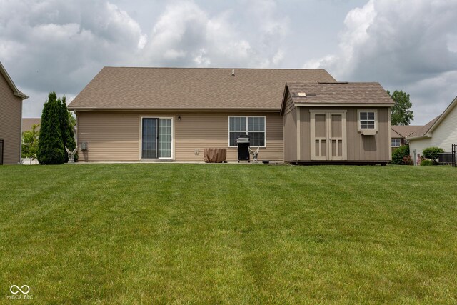 4353 W Parkway Ct, New Palestine, IN 46163 - rear view of house featuring a lawn and a shingled roof