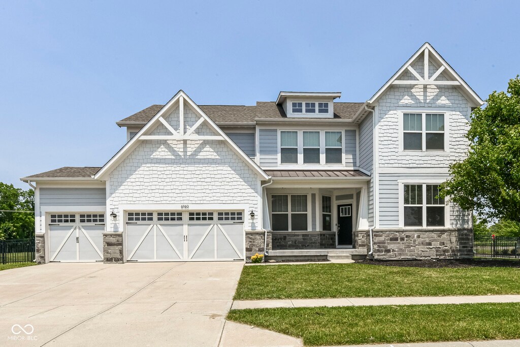 6160 Hardwick Dr, Whitestown, IN 46075 - craftsman-style house featuring stone siding, concrete driveway, an attached garage, a porch, and roof with shingles