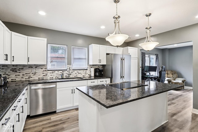 2928 Mounds Rd, Anderson, IN 46016 - kitchen featuring appliances with stainless steel finishes, tasteful backsplash, light wood-style flooring, white cabinetry, and recessed lighting