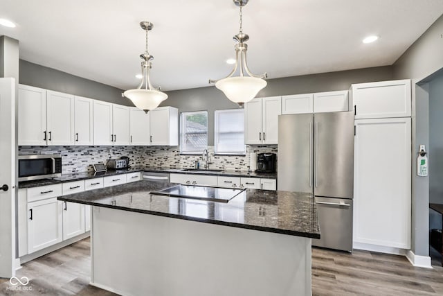 2928 Mounds Rd, Anderson, IN 46016 - kitchen featuring stainless steel appliances, light wood-style floors, white cabinetry, backsplash, and recessed lighting