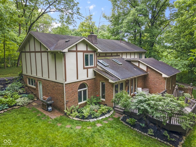 8310 Fall Creek Rd, Indianapolis, IN 46256 - back of house featuring brick siding, a chimney, and roof with shingles