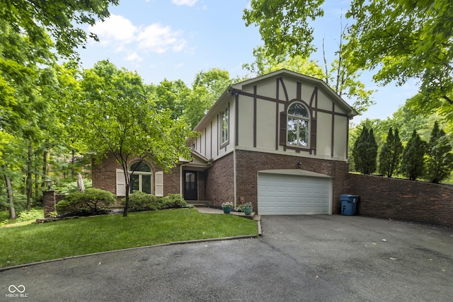 8310 Fall Creek Rd, Indianapolis, IN 46256 - tudor home with asphalt driveway, brick siding, a garage, a front lawn, and board and batten siding
