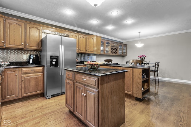 8310 Fall Creek Rd, Indianapolis, IN 46256 - kitchen featuring stainless steel refrigerator with ice dispenser, a center island, crown molding, brown cabinets, and light wood-style flooring