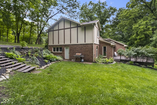 8310 Fall Creek Rd, Indianapolis, IN 46256 - view of side of property featuring brick siding, board and batten siding, a wooden deck, and a yard