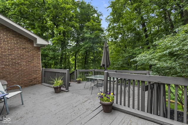 8310 Fall Creek Rd, Indianapolis, IN 46256 - deck featuring outdoor dining space and view of wooded area