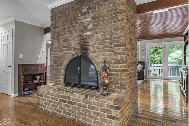 8310 Fall Creek Rd, Indianapolis, IN 46256 - unfurnished living room with wood finished floors, ornamental molding, and a brick fireplace