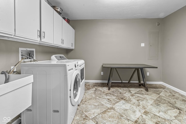 8310 Fall Creek Rd, Indianapolis, IN 46256 - washroom featuring cabinet space, washing machine and dryer, light stone finish floors, electric panel, and a textured ceiling