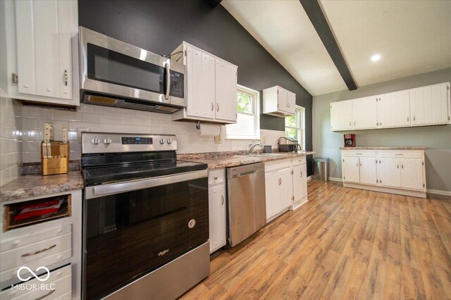 640 Shady Creek Ct, Greenwood, IN 46142 - kitchen with appliances with stainless steel finishes, white cabinetry, decorative backsplash, light wood finished floors, and recessed lighting