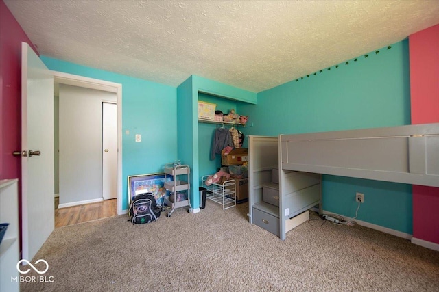 640 Shady Creek Ct, Greenwood, IN 46142 - bedroom with carpet flooring, a textured ceiling, a closet, and baseboards