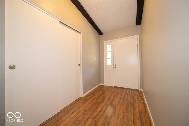 640 Shady Creek Ct, Greenwood, IN 46142 - doorway to outside featuring wood finished floors, baseboards, and a textured ceiling