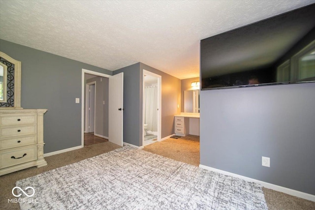 640 Shady Creek Ct, Greenwood, IN 46142 - carpeted bedroom featuring baseboards, a textured ceiling, and ensuite bath