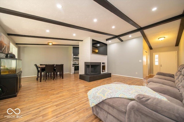 640 Shady Creek Ct, Greenwood, IN 46142 - living room with baseboards, light wood-style floors, beamed ceiling, recessed lighting, and a large fireplace