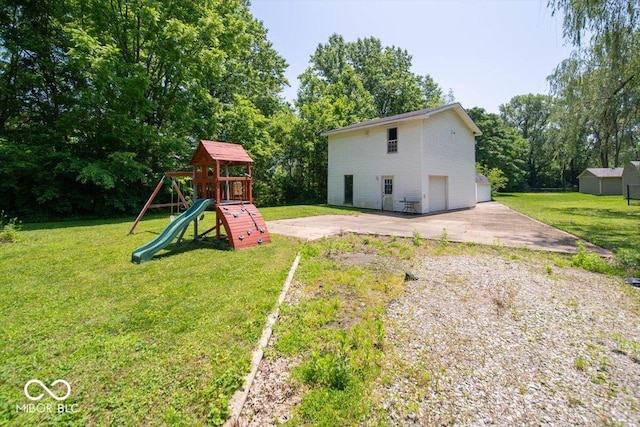 640 Shady Creek Ct, Greenwood, IN 46142 - view of green lawn with a playground, an outbuilding, and view of scattered trees