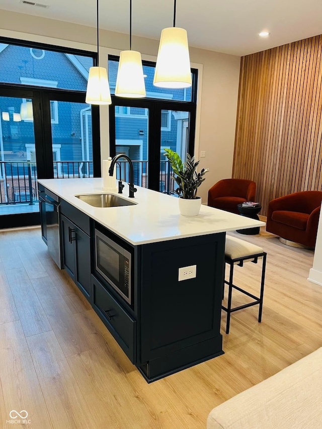 711 E 16th St, Indianapolis, IN 46202 - kitchen with stainless steel appliances, dark cabinetry, light wood finished floors, light countertops, and recessed lighting