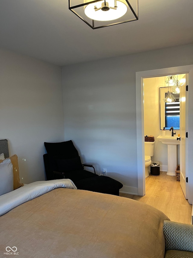 711 E 16th St, Indianapolis, IN 46202 - bedroom featuring wood finished floors and connected bathroom