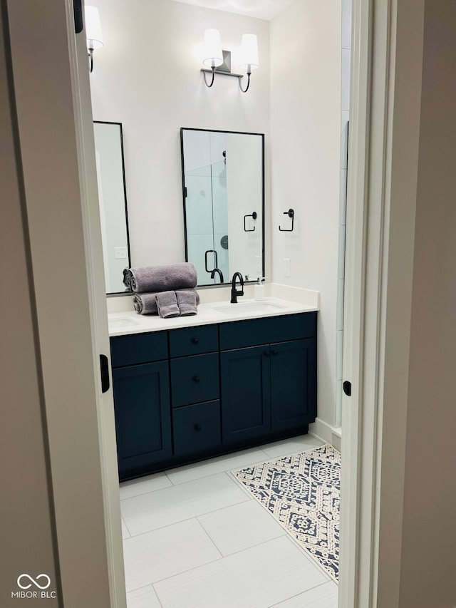711 E 16th St, Indianapolis, IN 46202 - full bathroom featuring double vanity, tile patterned floors, and a shower with door