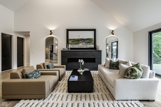 3549 W 131st St, Carmel, IN 46032 - living area featuring high vaulted ceiling, arched walkways, wood finished floors, and a fireplace