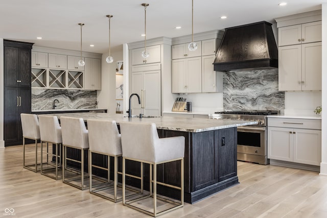 3549 W 131st St, Carmel, IN 46032 - kitchen featuring high end stove, custom range hood, decorative backsplash, light wood-style floors, and recessed lighting