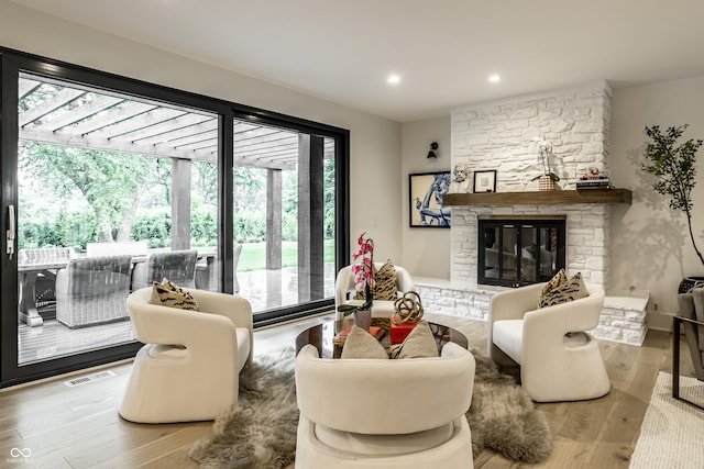 3549 W 131st St, Carmel, IN 46032 - living room with healthy amount of natural light, a fireplace, wood finished floors, and recessed lighting