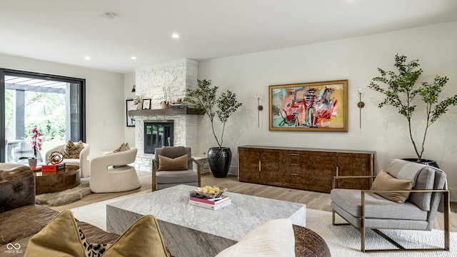 3549 W 131st St, Carmel, IN 46032 - living room featuring light wood-type flooring, a stone fireplace, and recessed lighting