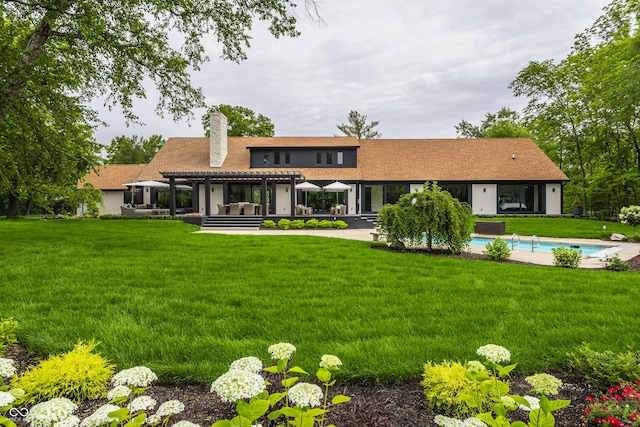 3549 W 131st St, Carmel, IN 46032 - rear view of property with a chimney, a pergola, a yard, an outdoor pool, and a patio